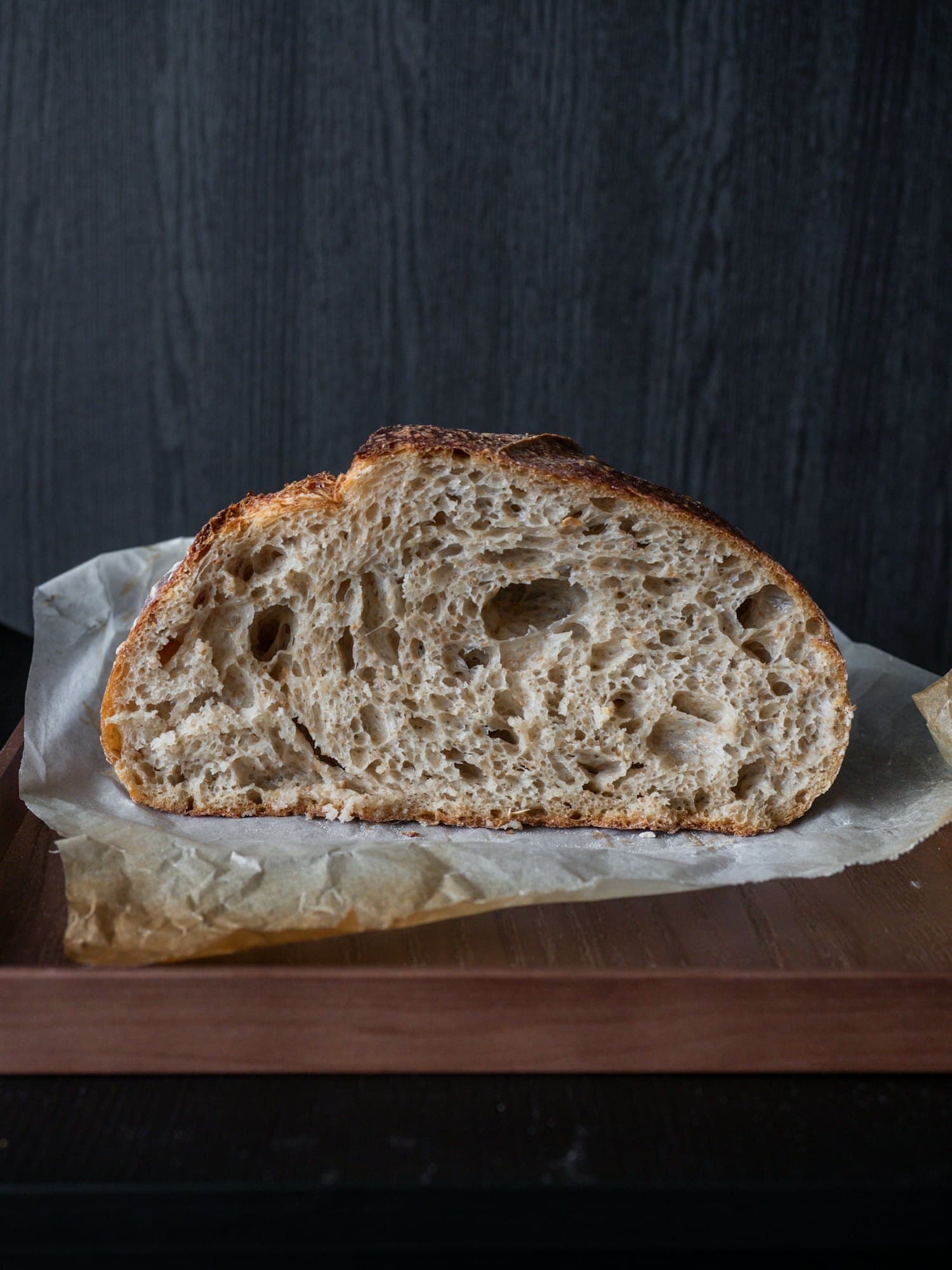 A round country sourdough boule with a rustic floured crust